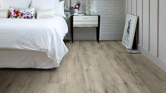 wide long planked luxury vinyl flooring in a bedroom
